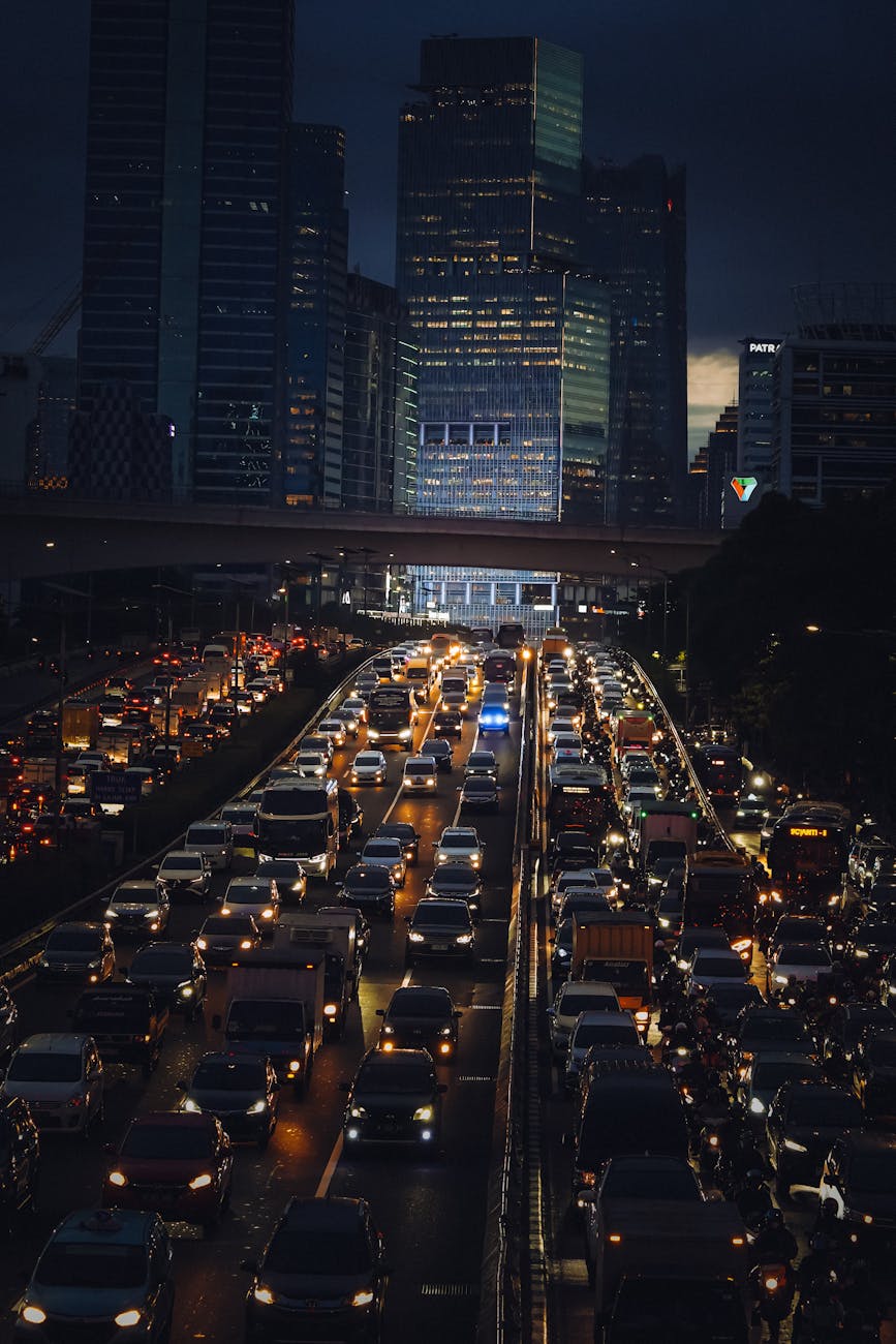 Stock photo of traffic jam to and from a dark city from Pexels.com