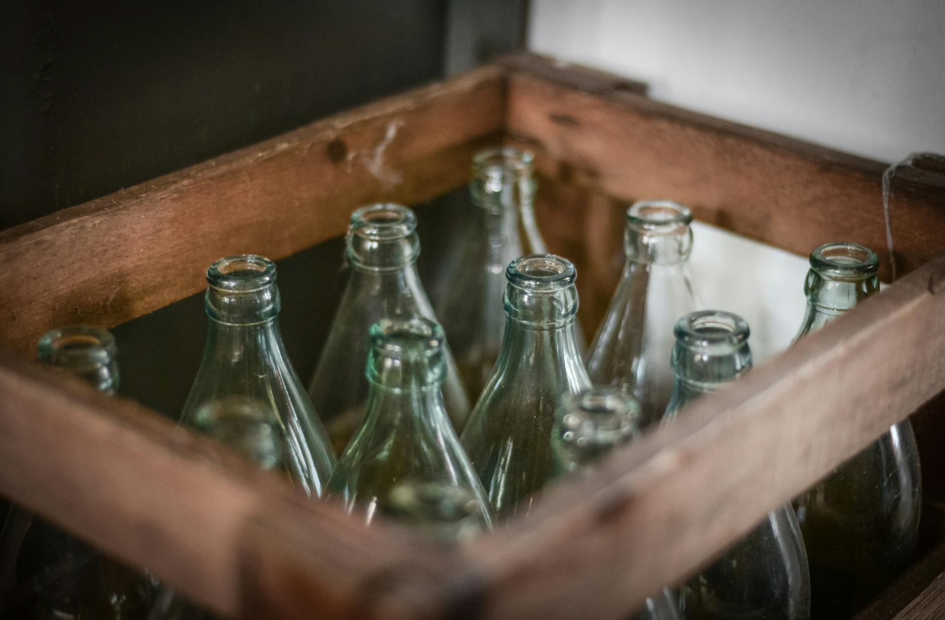 Stock photo of an old wooden crate of empty soda bottles from Pexels.com