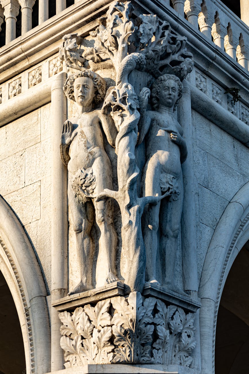Stock photo of building cornice sculpture depicting Adam and Eve from Pexels.com