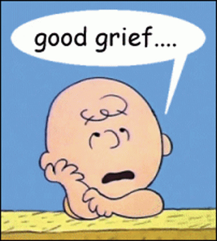 Charles Schultz cartoon character Charlie Brown resing his head on his hands with a speech bubble saying "Good Grief" over his head
