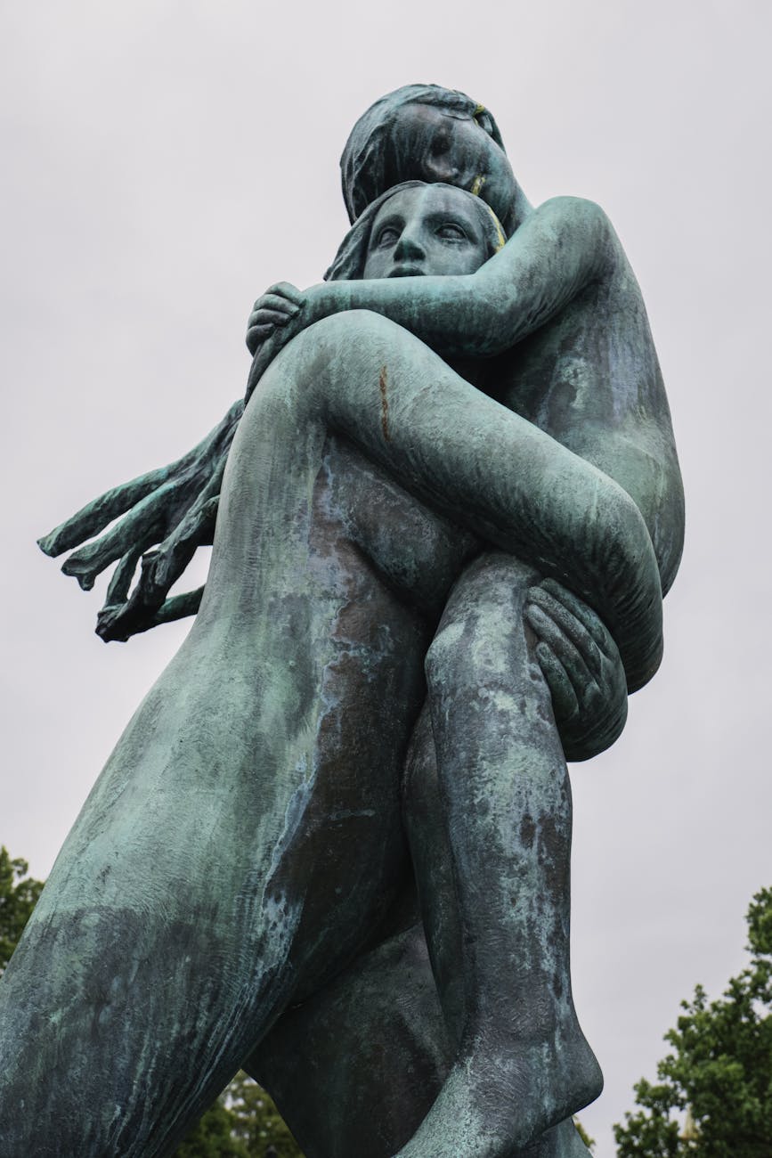 Stock photo of oxidized bronze statue of a person holding a child from Pexels.com 