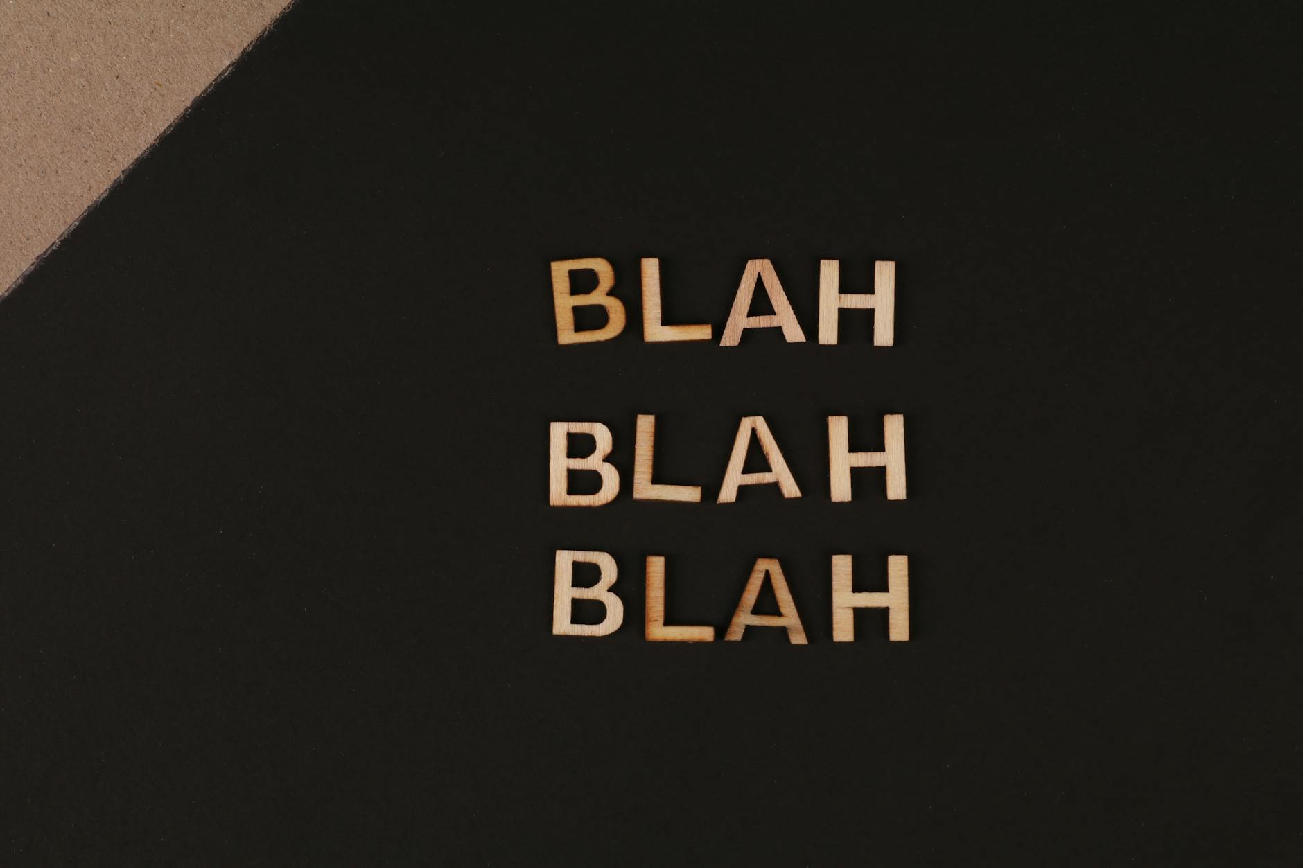 Stock photo of gold text on black background reading "BLAH BLAH BLAH" from Pexels.com