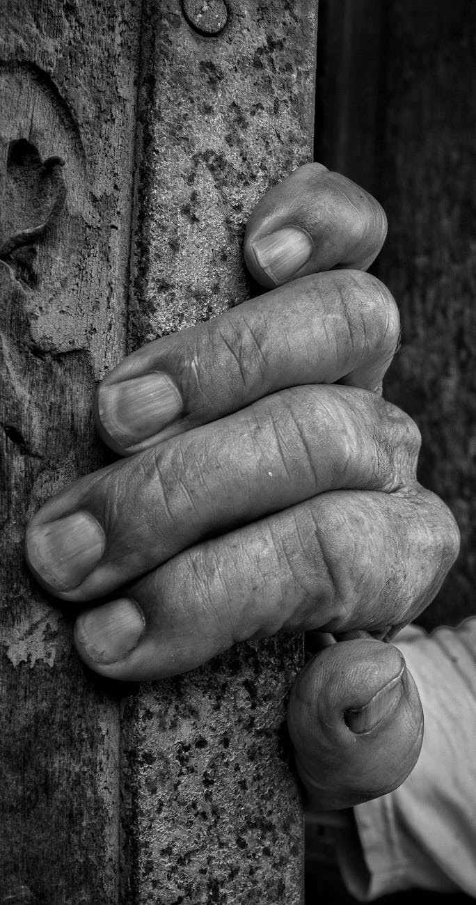 Stock B & W photo of human fingers hanging on for dear life to something from Pexels.com 