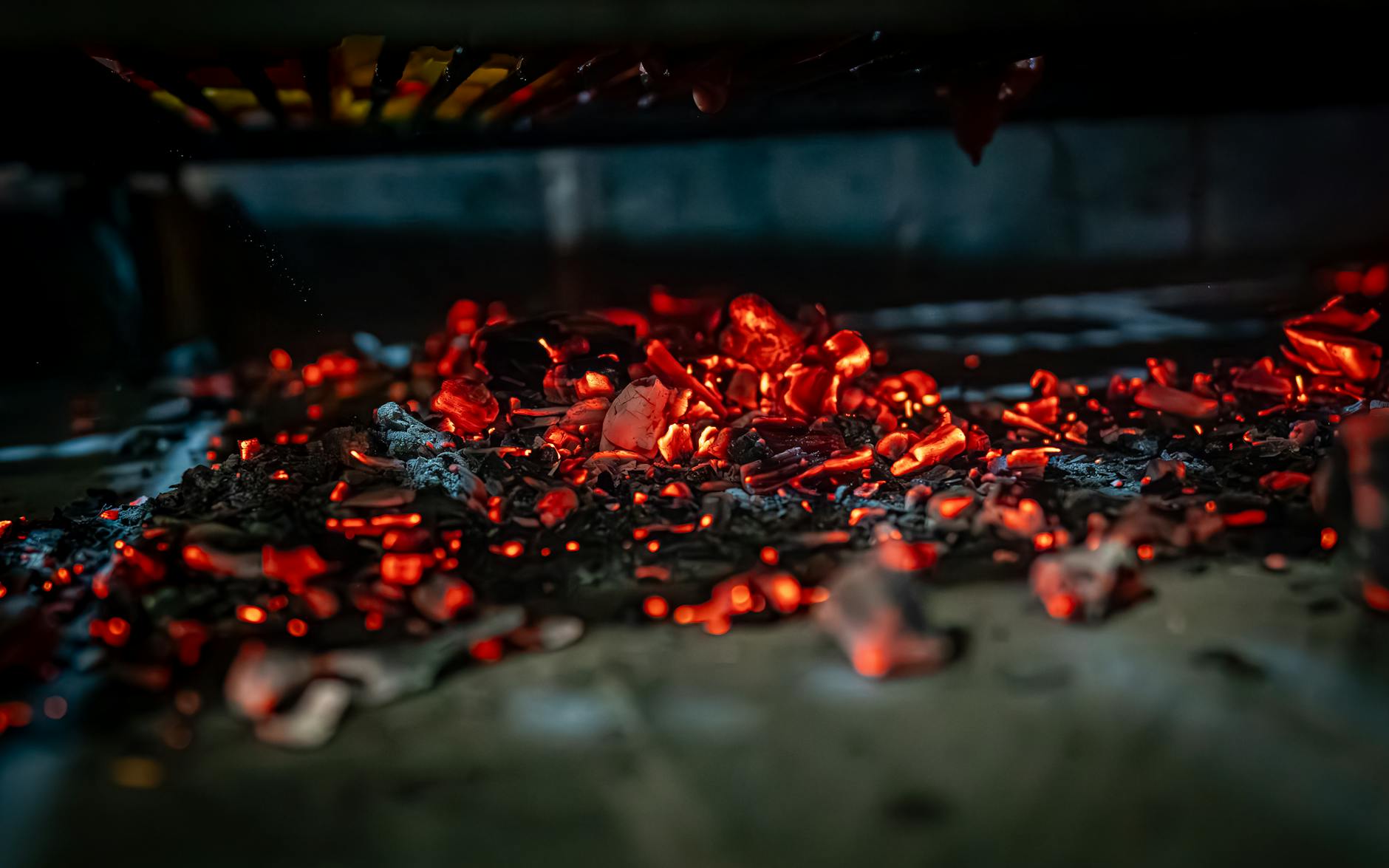 Stock photo of glowing red embers in a small heap of ash on the floor from Pexels.com