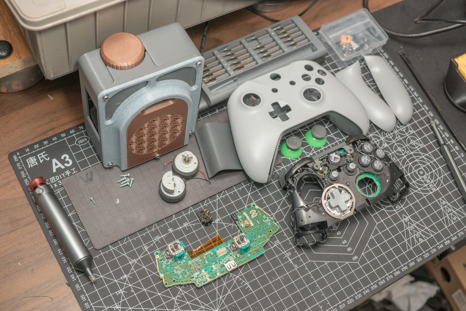 Stock photo of a video game controller reduced to its parts on a workbench from Pexels.com 