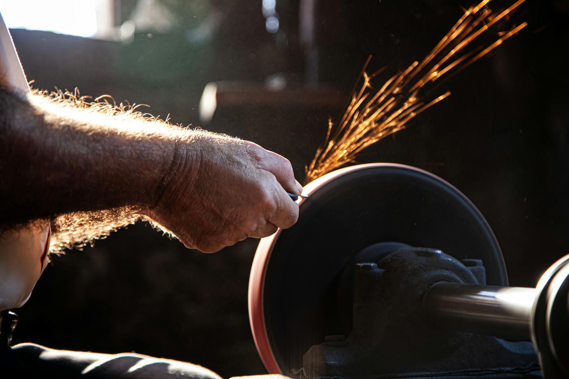 Stock photo of sparks flying off a grinding wheel as it hones a piece of metal from Pexels.com 