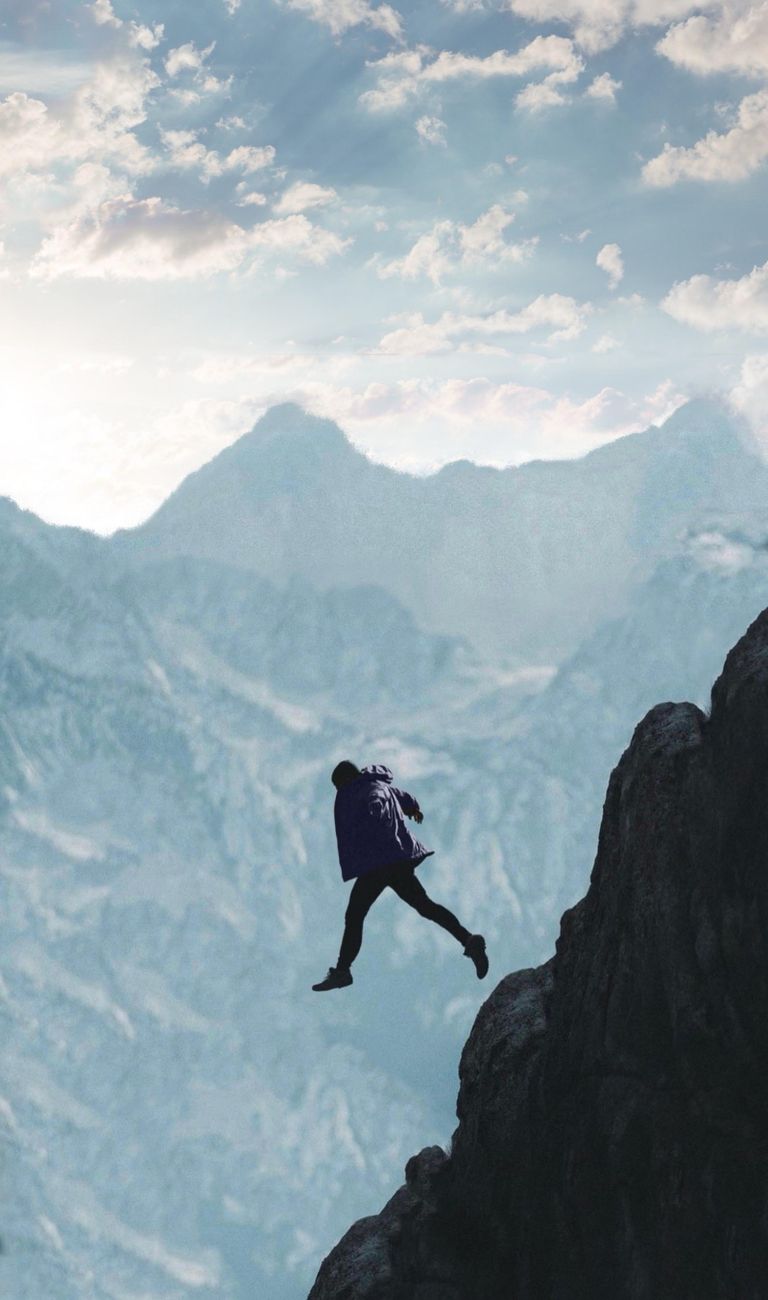Stock photo of a person taking a leap of faith on a cliff fromPexels.com