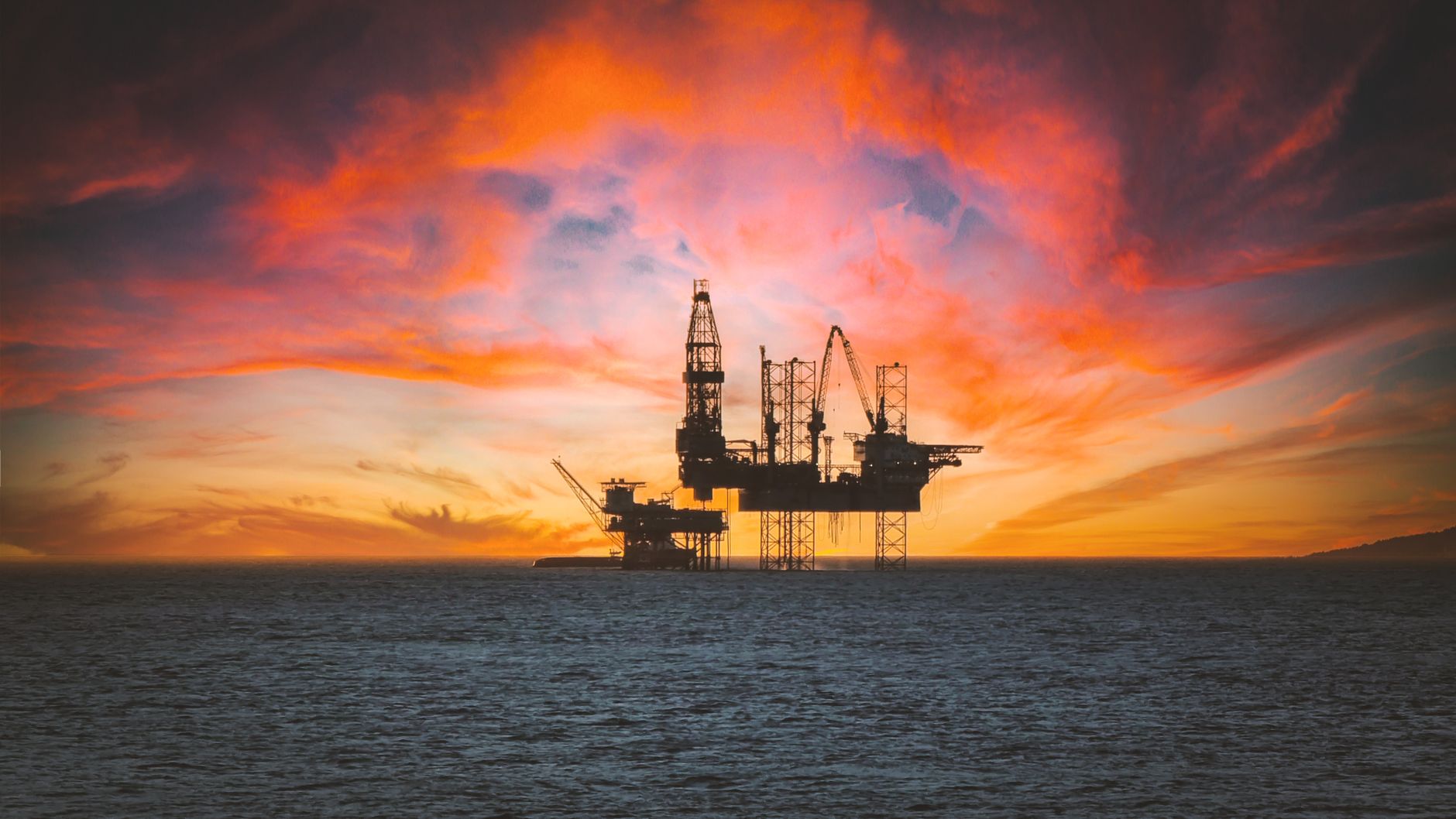 Stock photo of deep sea oil platform among gathering red clouds in the morning from Pexels.com 