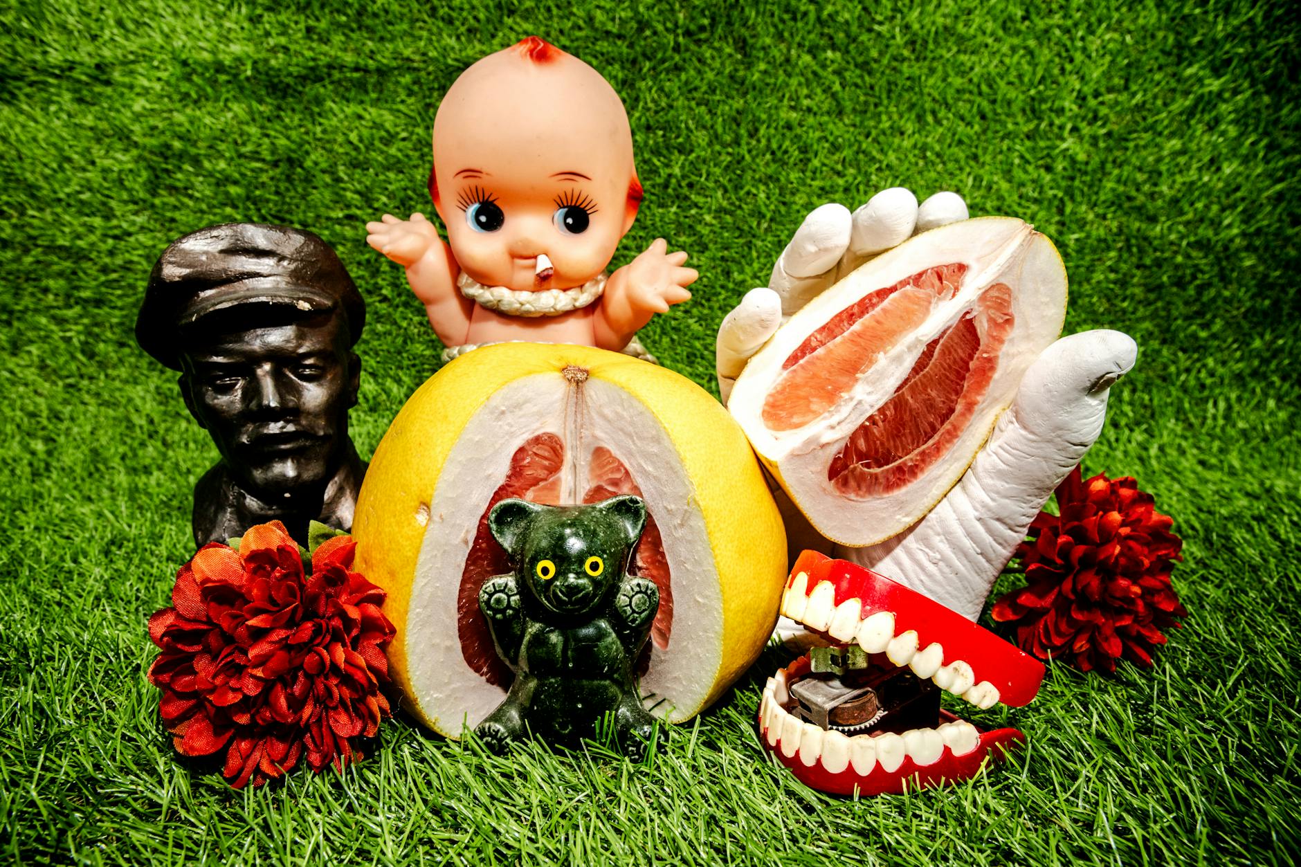 Stock photo of bust, baby, fruit wedge held in a gloved stand pom pom chattering teeth bug bear in sliced fruit and pom pom on the lawn from Pexels.com