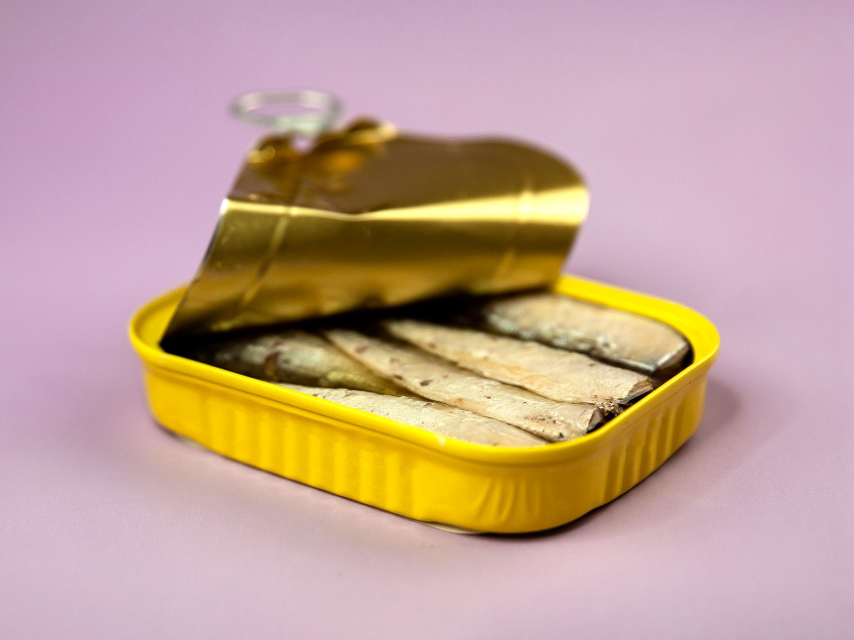 Stock photo of a half open tin of sardines in limbo from Pexels.com 
