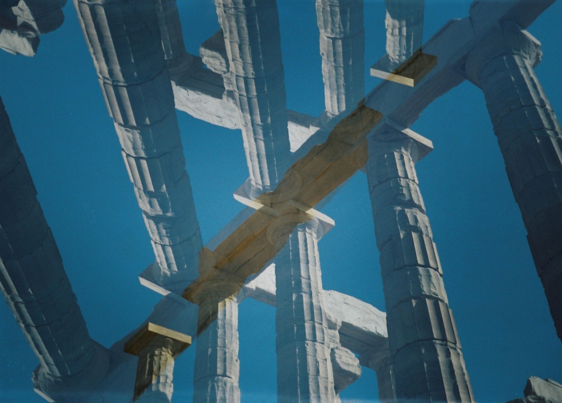 Stock photo of mirror image Doric columns intersecting diagonally mid frame from Pexels.com 