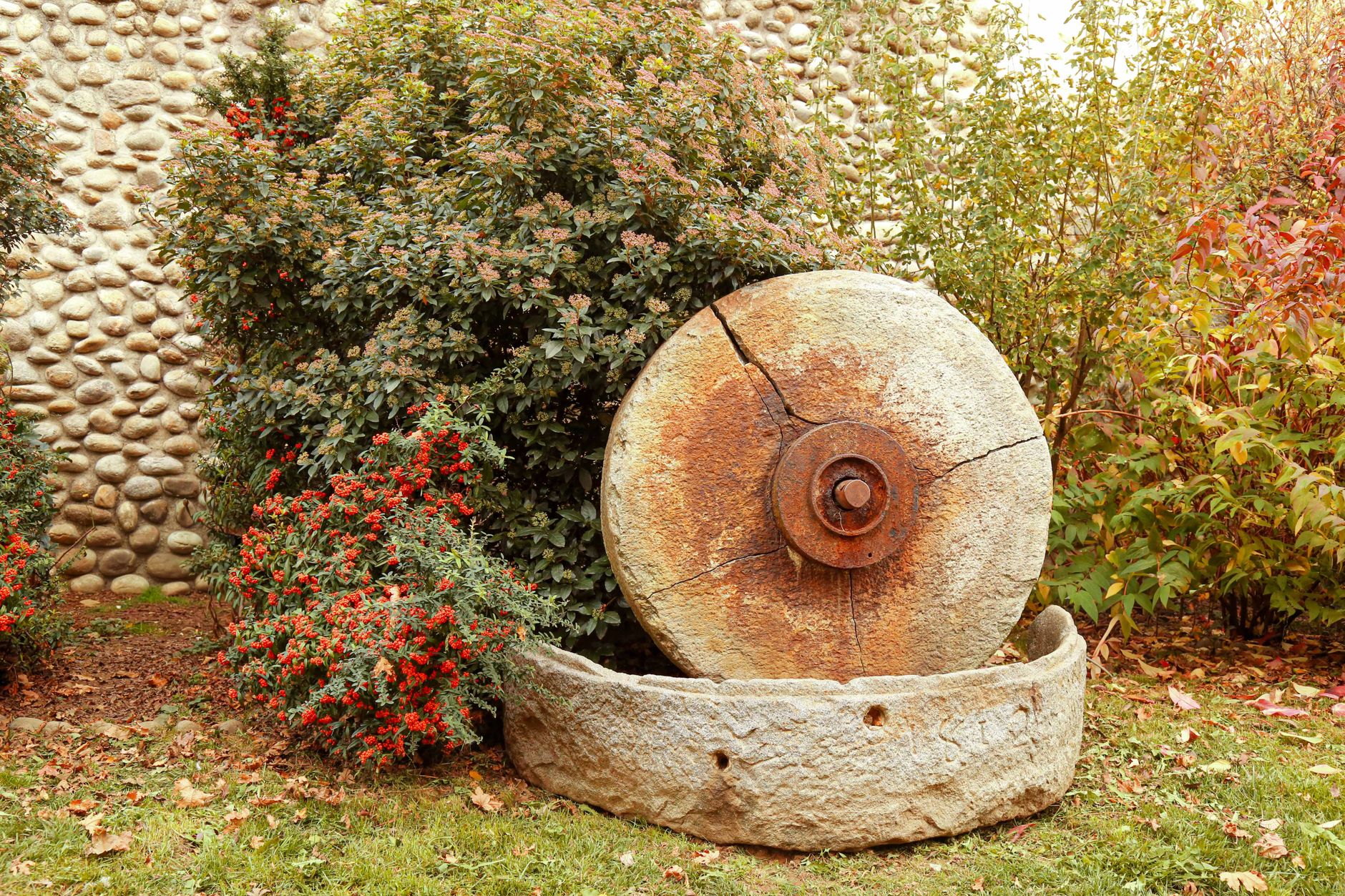 Stock photo of old millstone and basin in man tamed nature from Pexels.com 