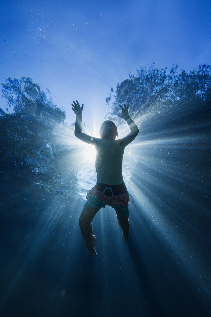Stock photo of a human floating underwater from Pexels.com 