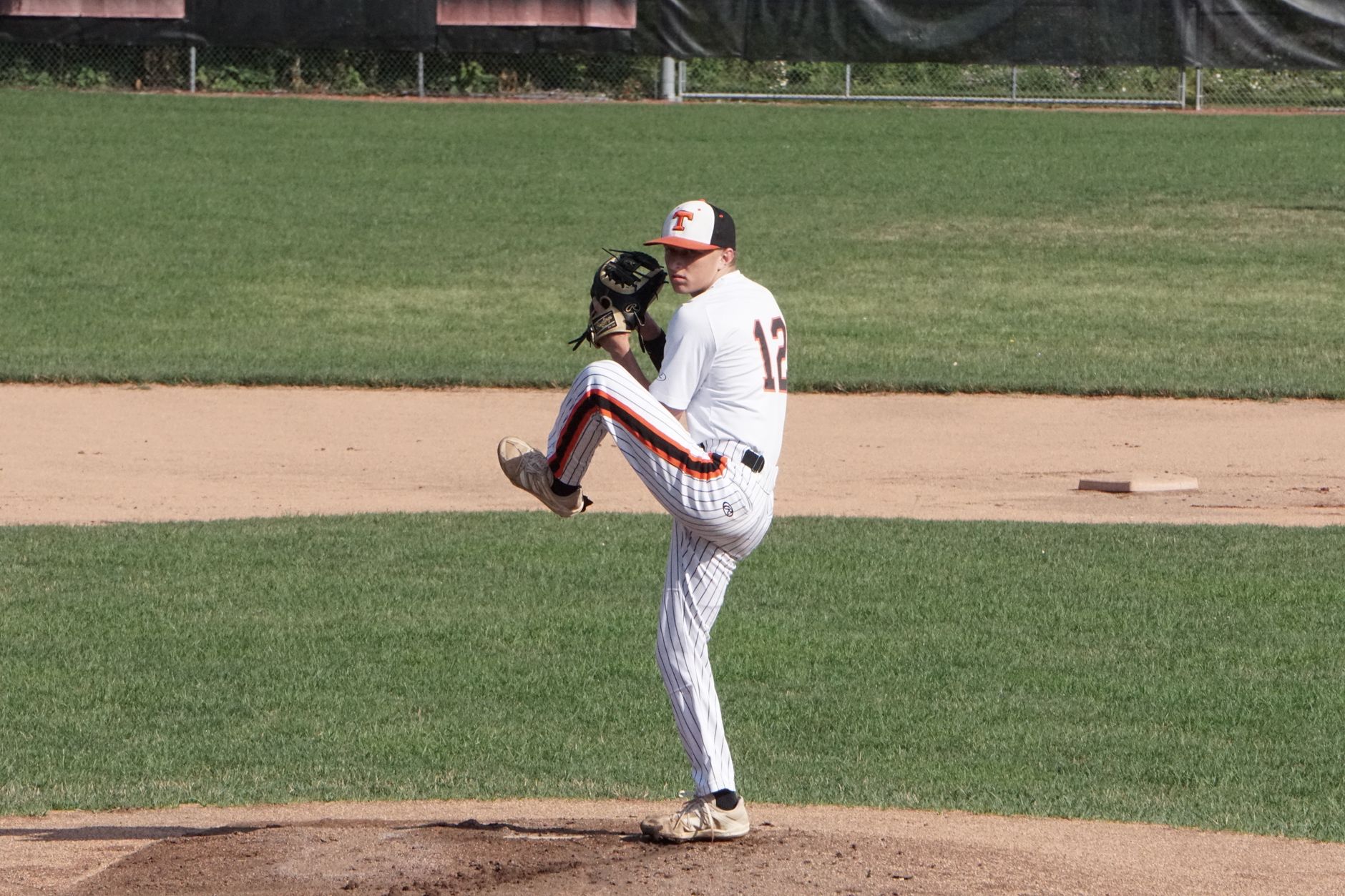 Stock photo of a baseball pitcher winding up on the mound from Pexels.com