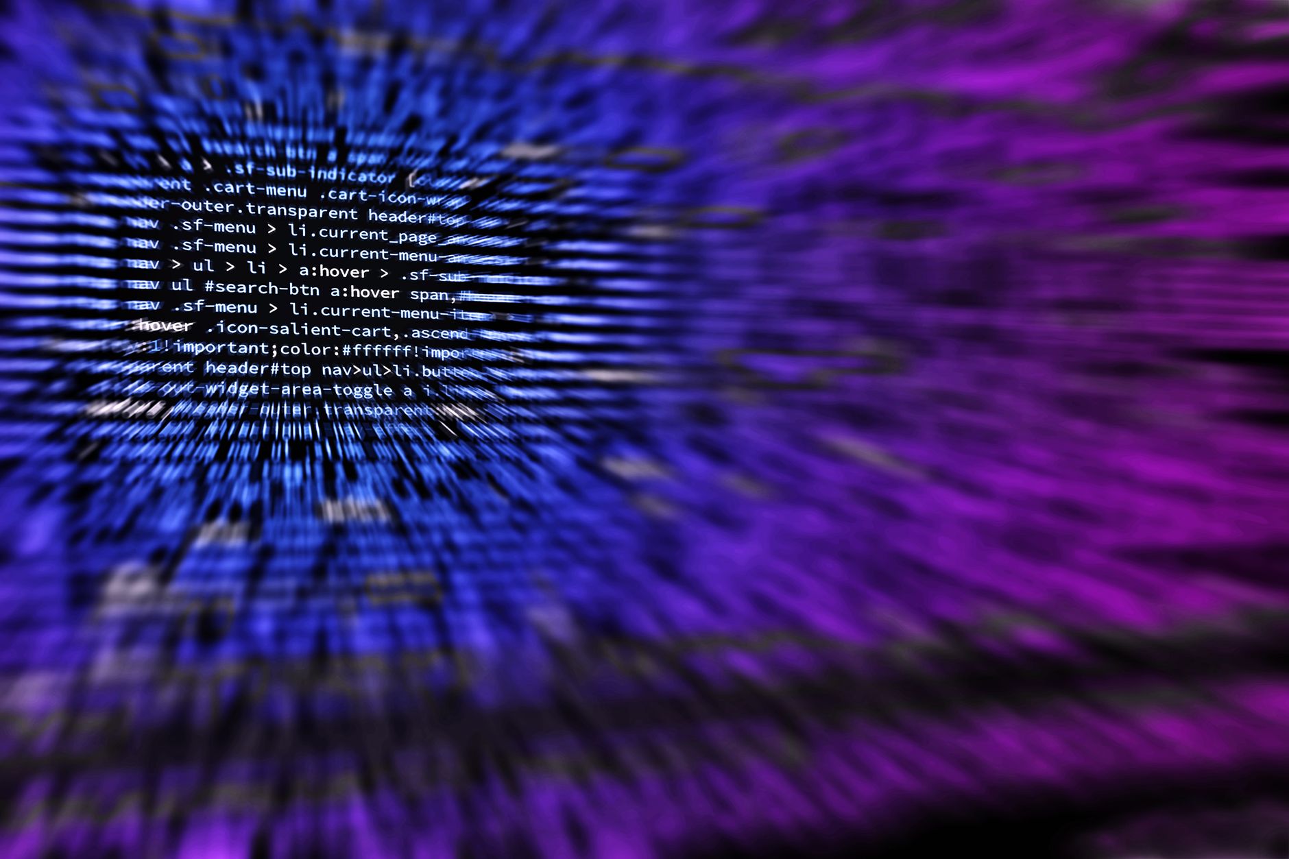 Stock photo shows lines of computer code rendered with a blue and purple visual effect that creates a sense of depth and motion from Pexels.com