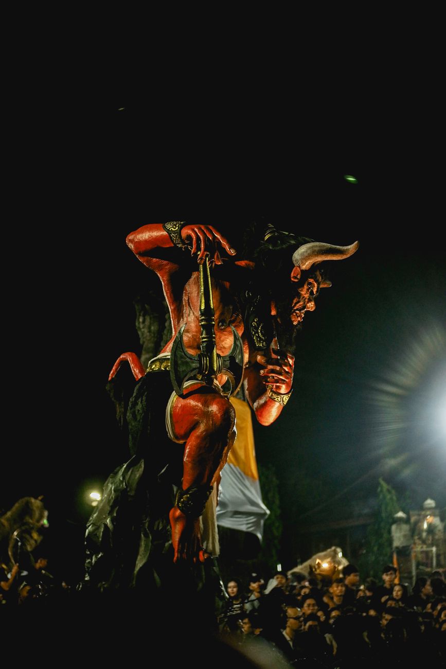 Stock image shows a large, red, horned Ogoh-Ogoh statue being carried through a crowd during a night parade in Bali, Indonesia Pexels.com